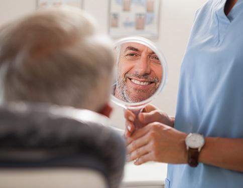 Man looking at smile with tooth-colored filling