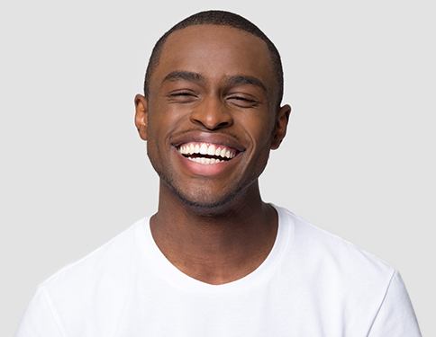Smiling man with straight teeth thanks to Invisalign in Tyler