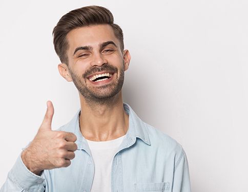 Man giving thumbs up after dental appointment