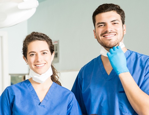 Two smiling dental team members