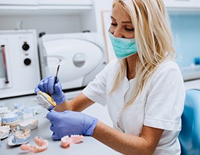 Dental lab technician working on dentures