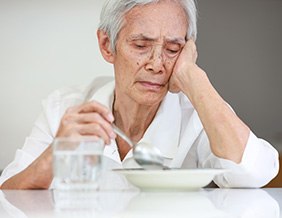 Woman having trouble eating