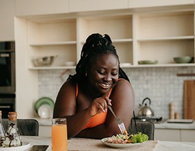 Woman eating healthy lunch at home