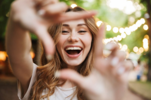 Woman outlining her beautiful smile with her hands